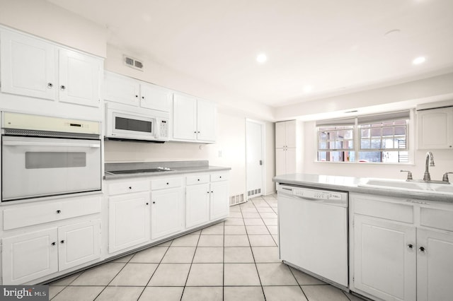 kitchen with light countertops, white appliances, visible vents, and white cabinetry