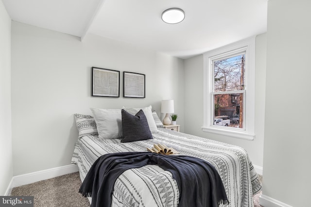 carpeted bedroom featuring baseboards