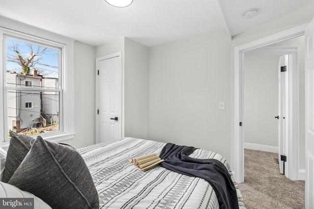 carpeted bedroom featuring baseboards