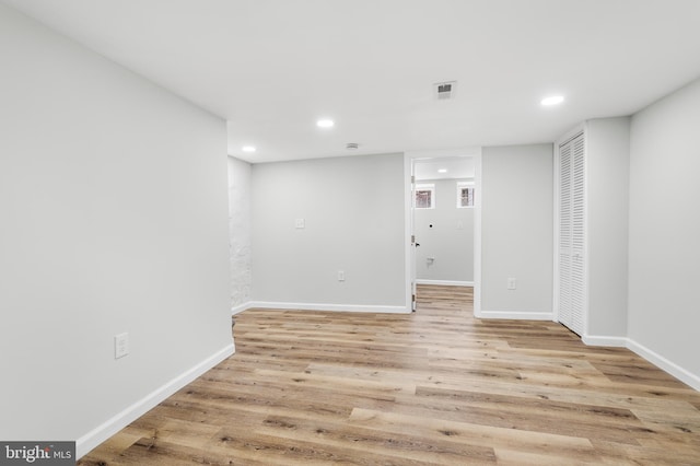 unfurnished room featuring recessed lighting, visible vents, light wood-style flooring, and baseboards