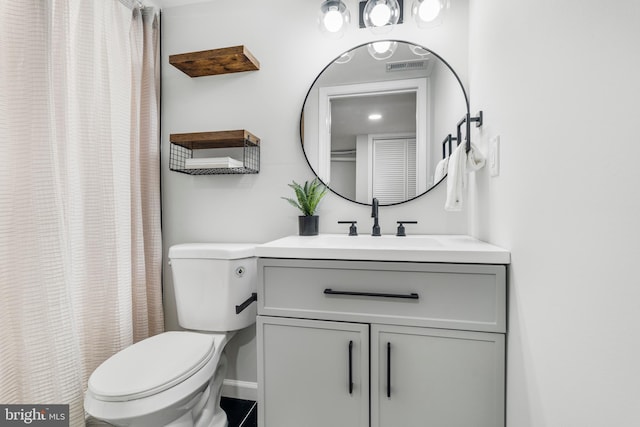 bathroom featuring visible vents, vanity, and toilet