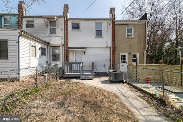 back of house with central air condition unit and fence private yard