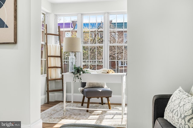 interior space featuring baseboards and wood finished floors