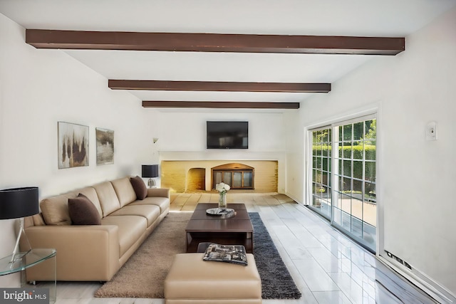 living room with beamed ceiling and a glass covered fireplace