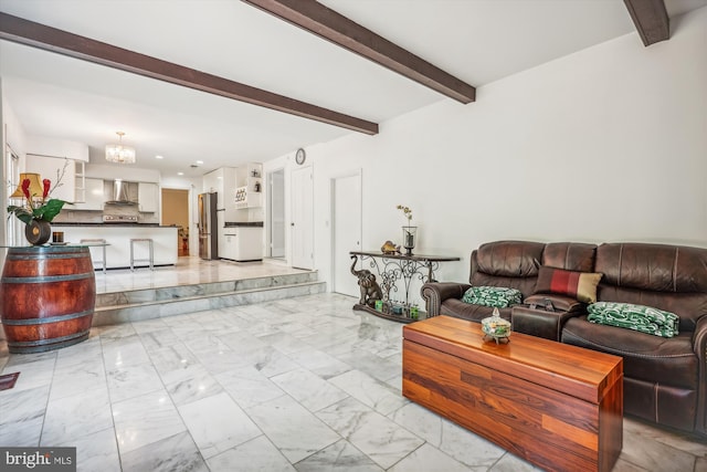 living room featuring marble finish floor, beamed ceiling, and a notable chandelier