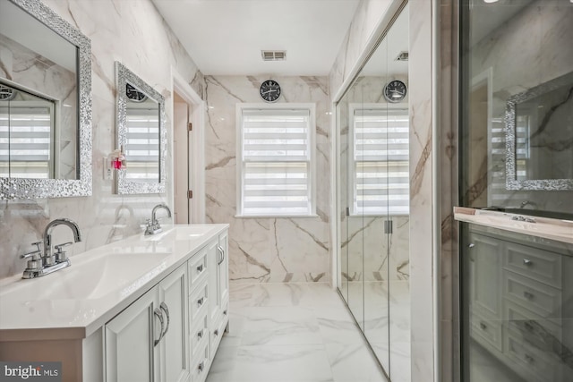 full bathroom with double vanity, marble finish floor, visible vents, and a sink