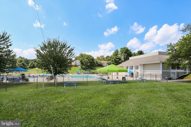 view of yard with fence and a community pool