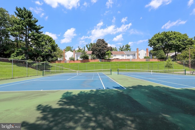 view of sport court featuring fence