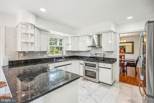 kitchen with appliances with stainless steel finishes, white cabinets, wall chimney exhaust hood, and open shelves