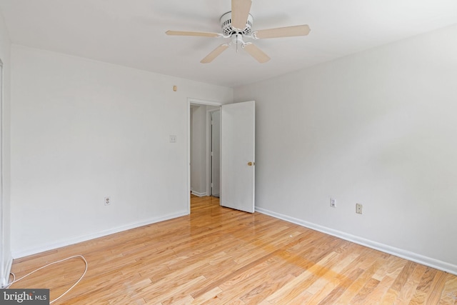 unfurnished room with a ceiling fan, light wood-type flooring, and baseboards