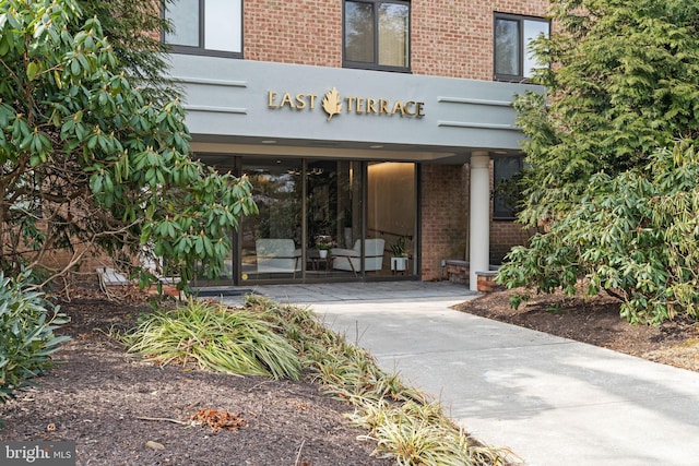 view of exterior entry featuring brick siding