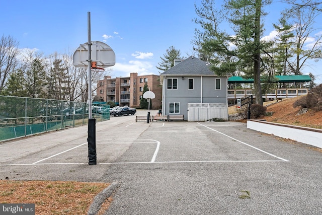 view of basketball court with community basketball court and fence