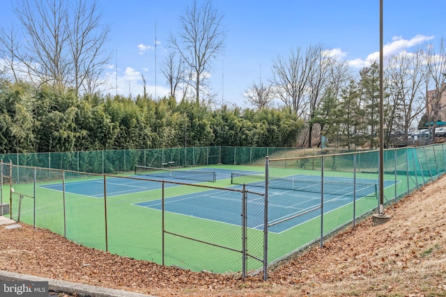 view of sport court featuring fence