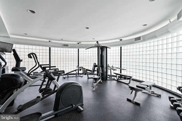 exercise room featuring expansive windows and visible vents