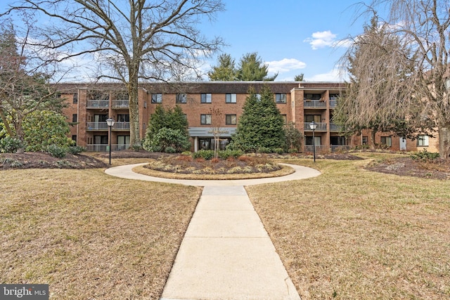 view of home's community with a yard