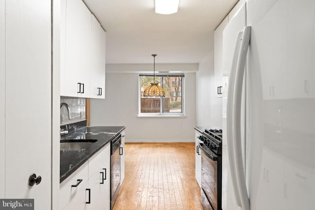 kitchen featuring black appliances, white cabinetry, light wood-style floors, and a sink