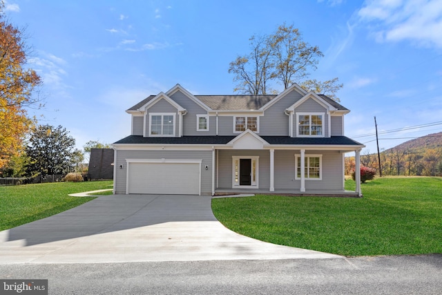 view of front of house featuring covered porch, driveway, a front yard, and an attached garage