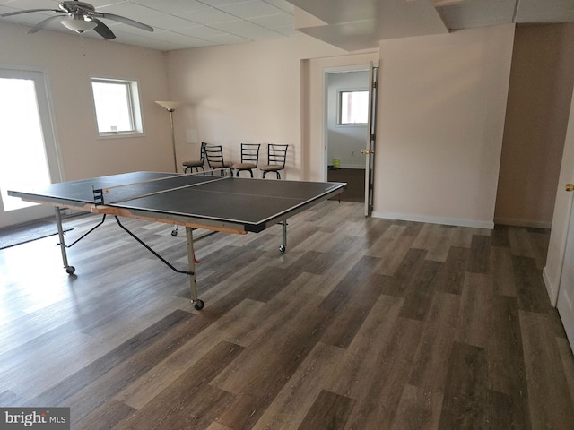 recreation room featuring baseboards, ceiling fan, and wood finished floors