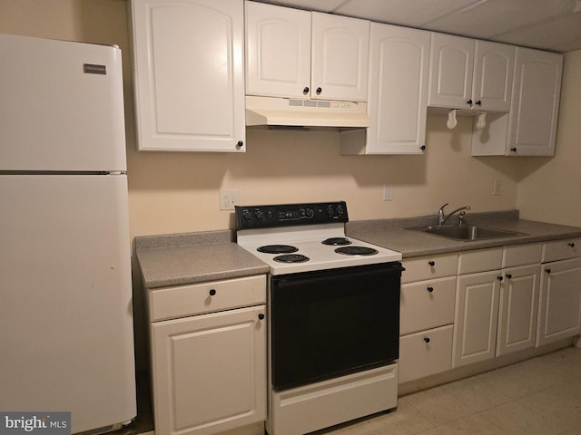 kitchen with range with electric cooktop, under cabinet range hood, a sink, freestanding refrigerator, and white cabinets