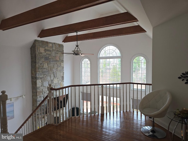 hall featuring an upstairs landing, vaulted ceiling with beams, baseboards, and wood finished floors