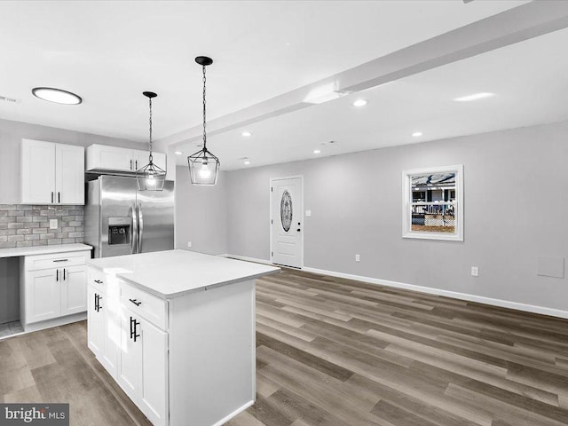 kitchen featuring white cabinetry, backsplash, wood finished floors, and stainless steel fridge with ice dispenser