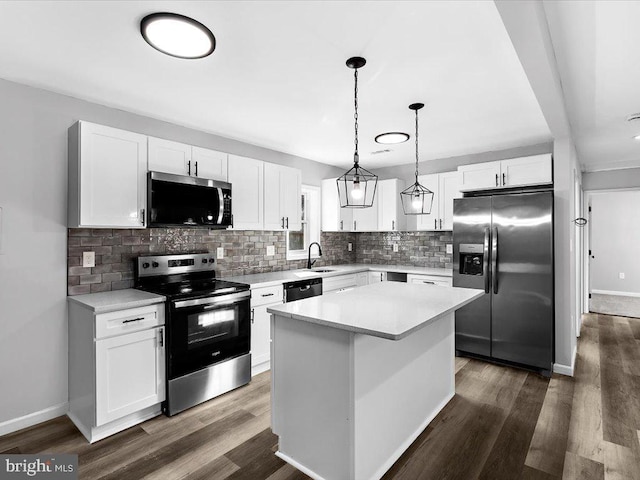 kitchen with white cabinets, stainless steel appliances, and dark wood finished floors