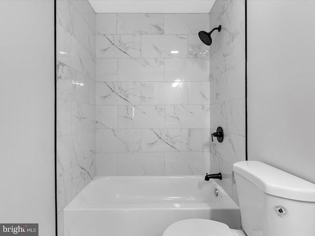 bathroom featuring shower / washtub combination and toilet