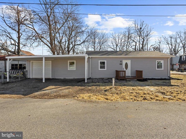 ranch-style house featuring a garage and driveway