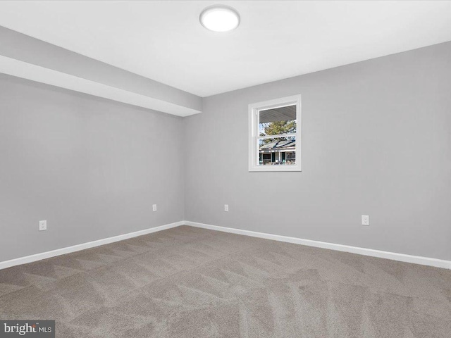 carpeted empty room with baseboards