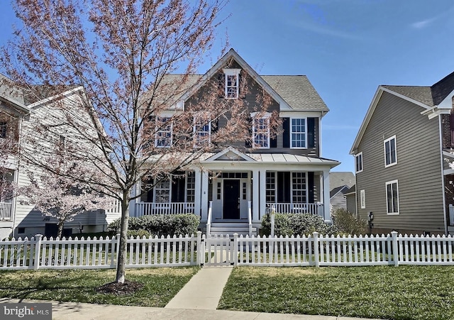 view of front of home with a fenced front yard and covered porch