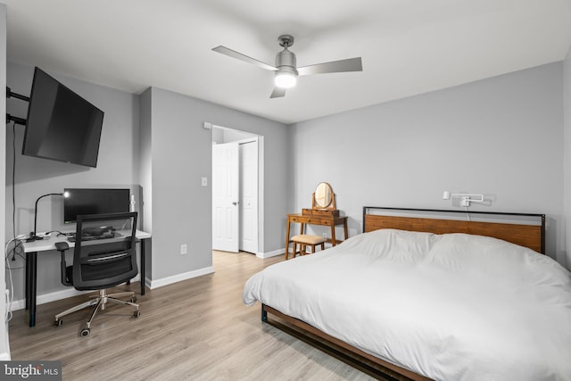 bedroom featuring ceiling fan, light wood finished floors, and baseboards