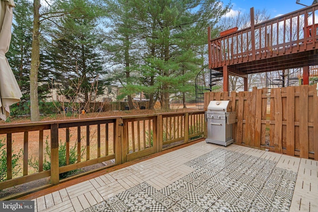 deck featuring stairs, fence, and area for grilling