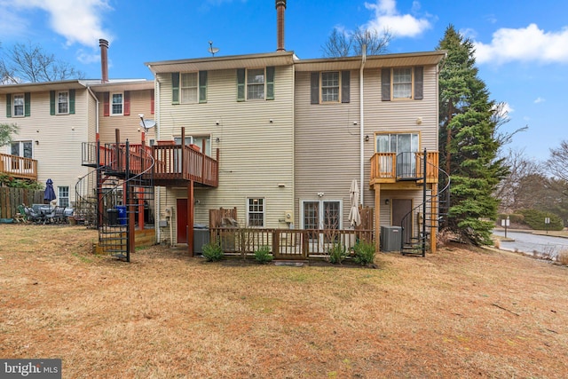 rear view of property with central AC, a yard, a wooden deck, and stairs