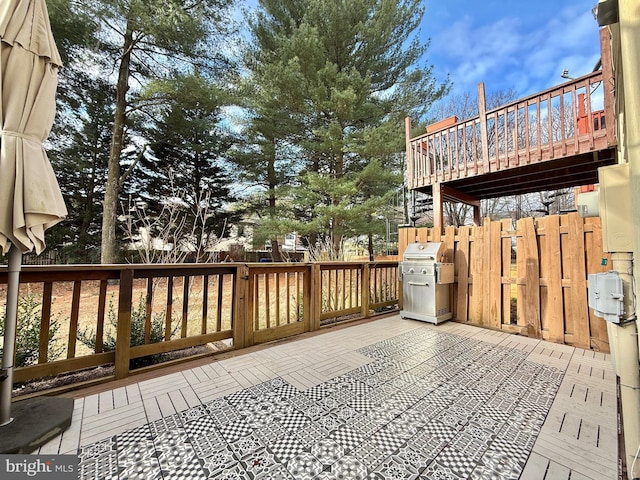 wooden deck featuring a grill