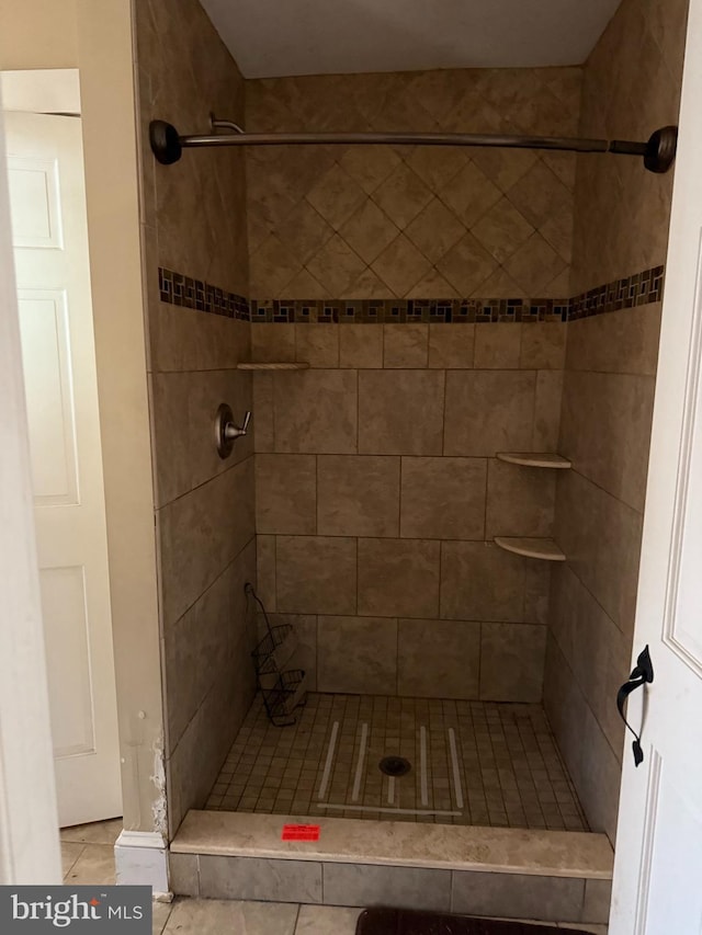 full bath with a stall shower and tile patterned floors