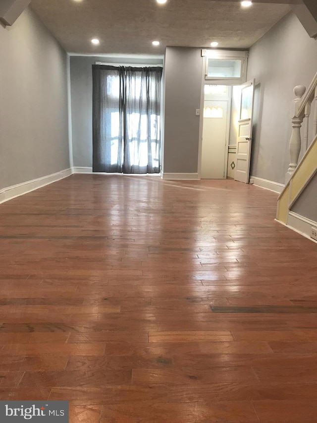 interior space featuring recessed lighting, baseboards, stairway, and hardwood / wood-style floors