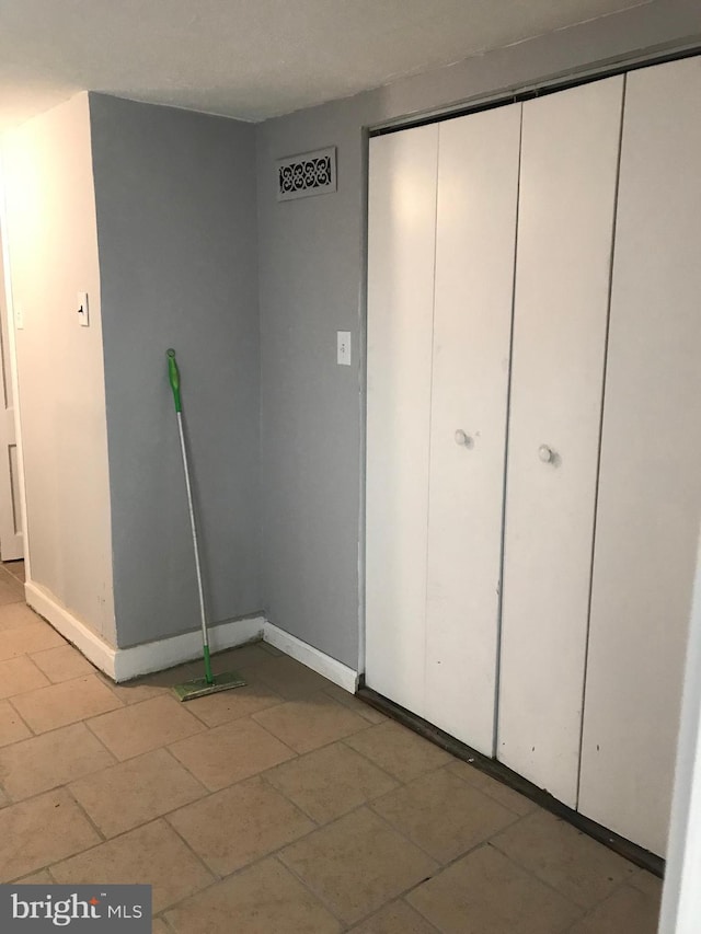 interior space with a closet and baseboards