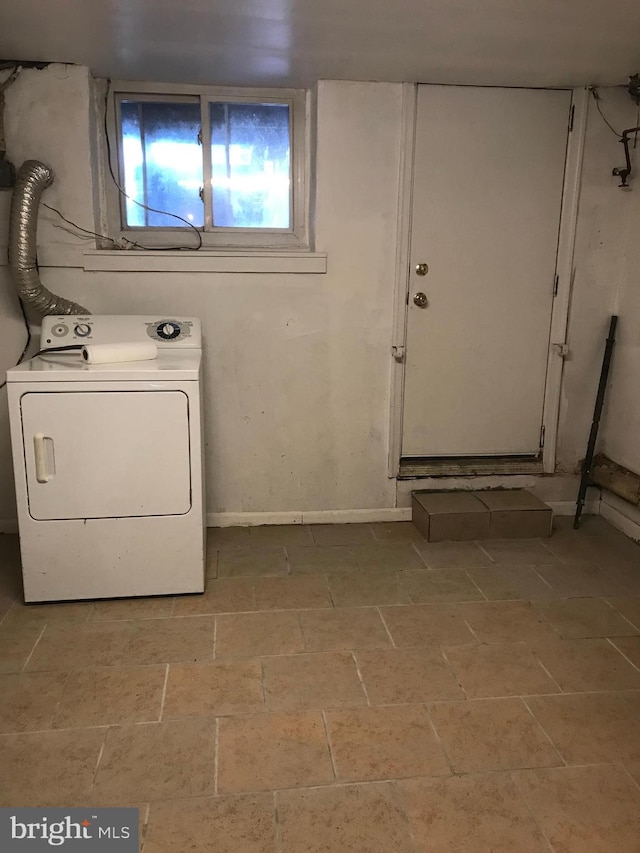 clothes washing area with laundry area, baseboards, and washer / clothes dryer