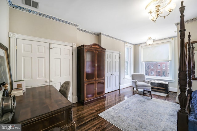 home office featuring baseboards, dark wood-style floors, visible vents, and a chandelier