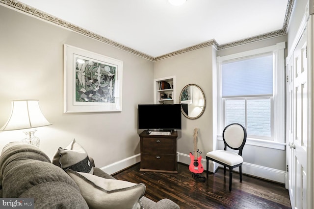 living area with baseboards and wood finished floors