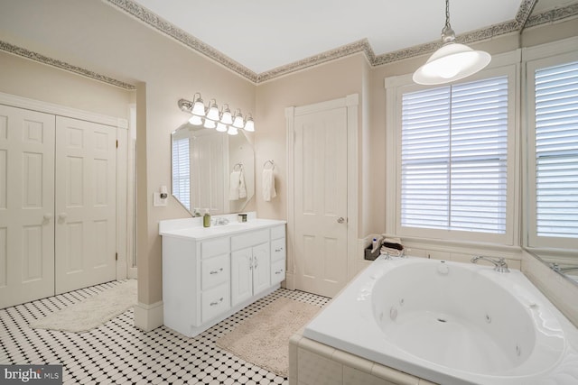 full bathroom featuring ornamental molding, vanity, a whirlpool tub, and a closet