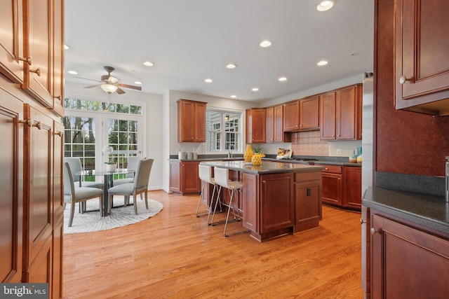 kitchen featuring light wood-style floors, ceiling fan, dark countertops, and recessed lighting