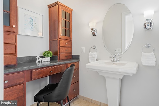 bathroom with a sink and tile patterned floors