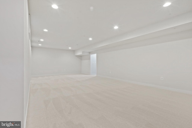 finished basement with baseboards, recessed lighting, and light colored carpet