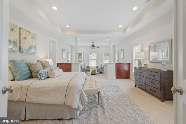 bedroom featuring crown molding, decorative columns, recessed lighting, light carpet, and a raised ceiling
