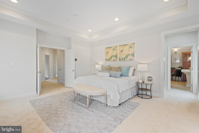 bedroom featuring a tray ceiling, recessed lighting, and light colored carpet