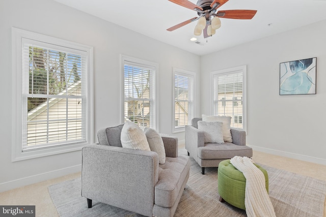 sitting room with carpet floors, baseboards, and a healthy amount of sunlight