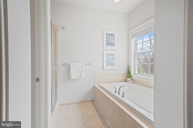full bathroom featuring a shower stall, tile patterned floors, baseboards, and a garden tub