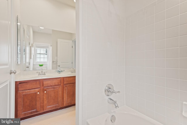 bathroom featuring a sink, double vanity, and shower / bathing tub combination
