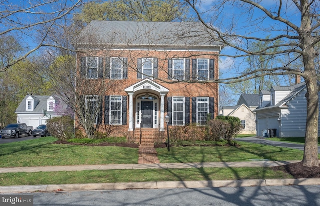 view of front of property with brick siding and a front yard